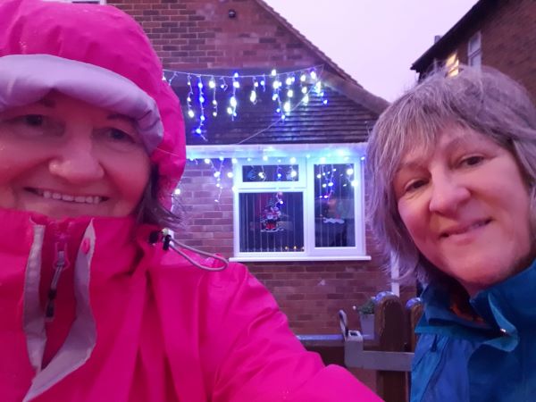 Two women enjoying local Christmas decorations on their walk